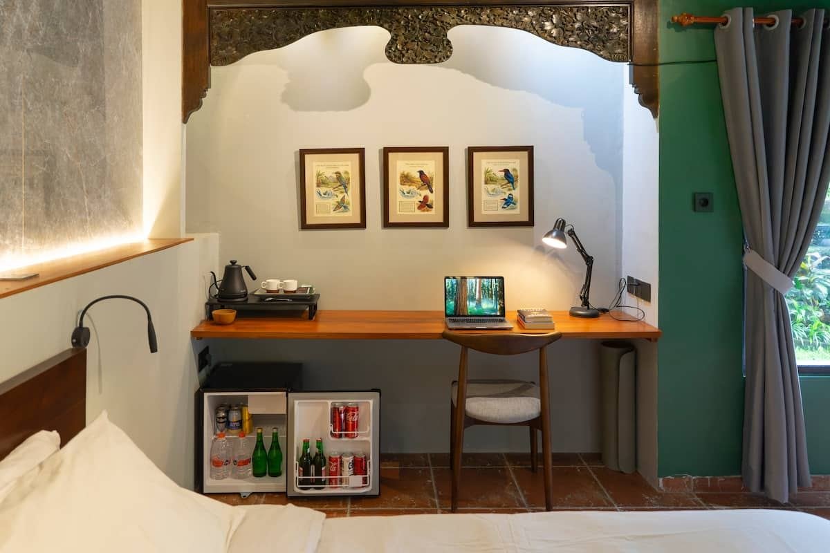 Desk, kettle and mini fridge at the foot of the bed